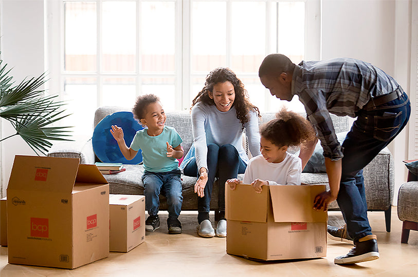 Smiling Family in Living Room with Best Choice Products Boxes